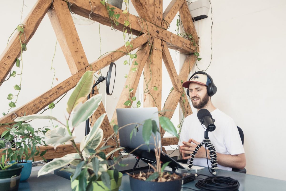 a man in white shirt doing audio podcast